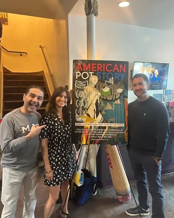 A filmmaker with fans beside a festival poster