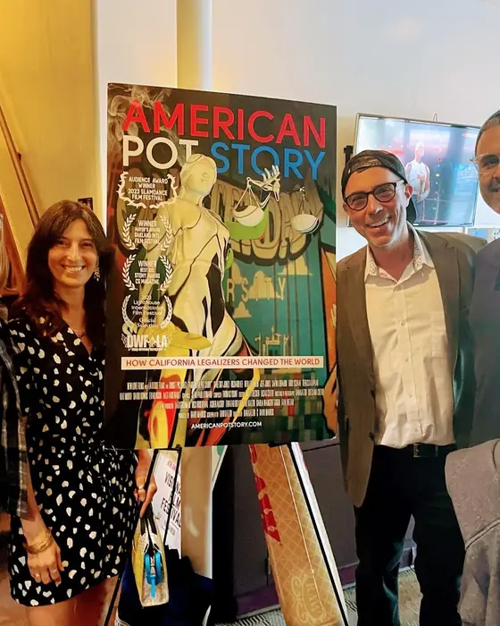 Filmmakers with their film poster inside the cinema